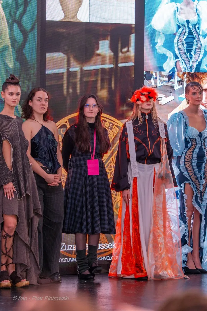 Kilka młodych kobiet, trzy prezentują futurystyczne projekty ubiorów